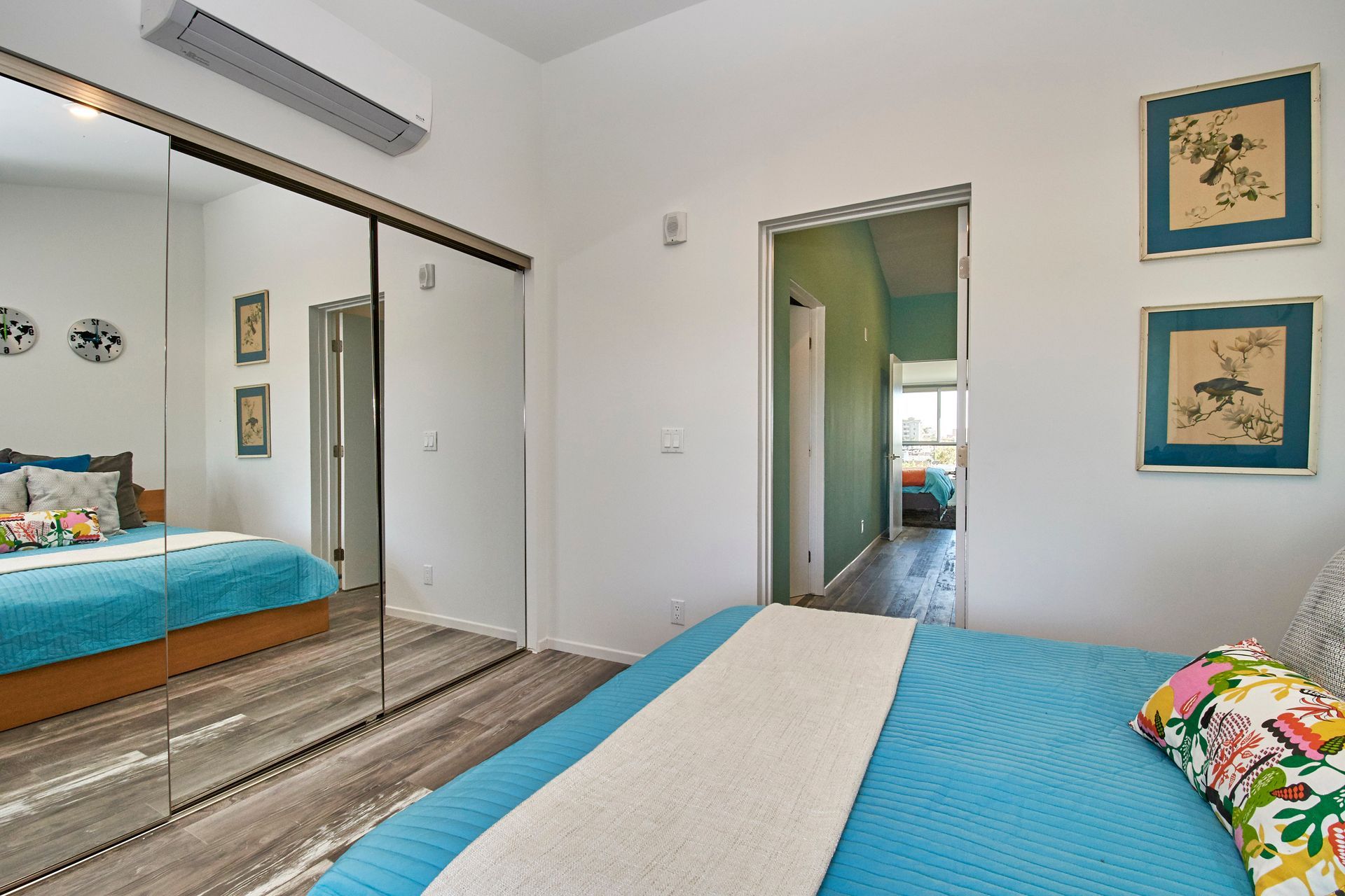 A bedroom with a bed and a sliding glass door