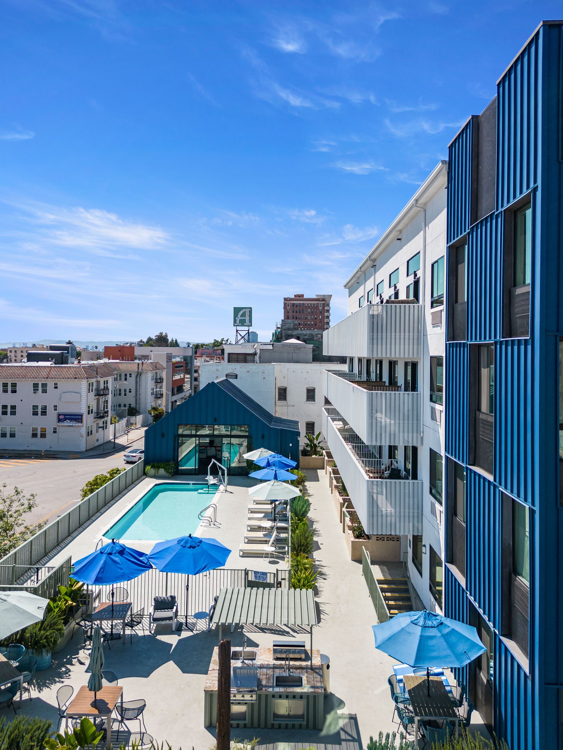 4Mica aerial view of a hotel with a pool and umbrellas