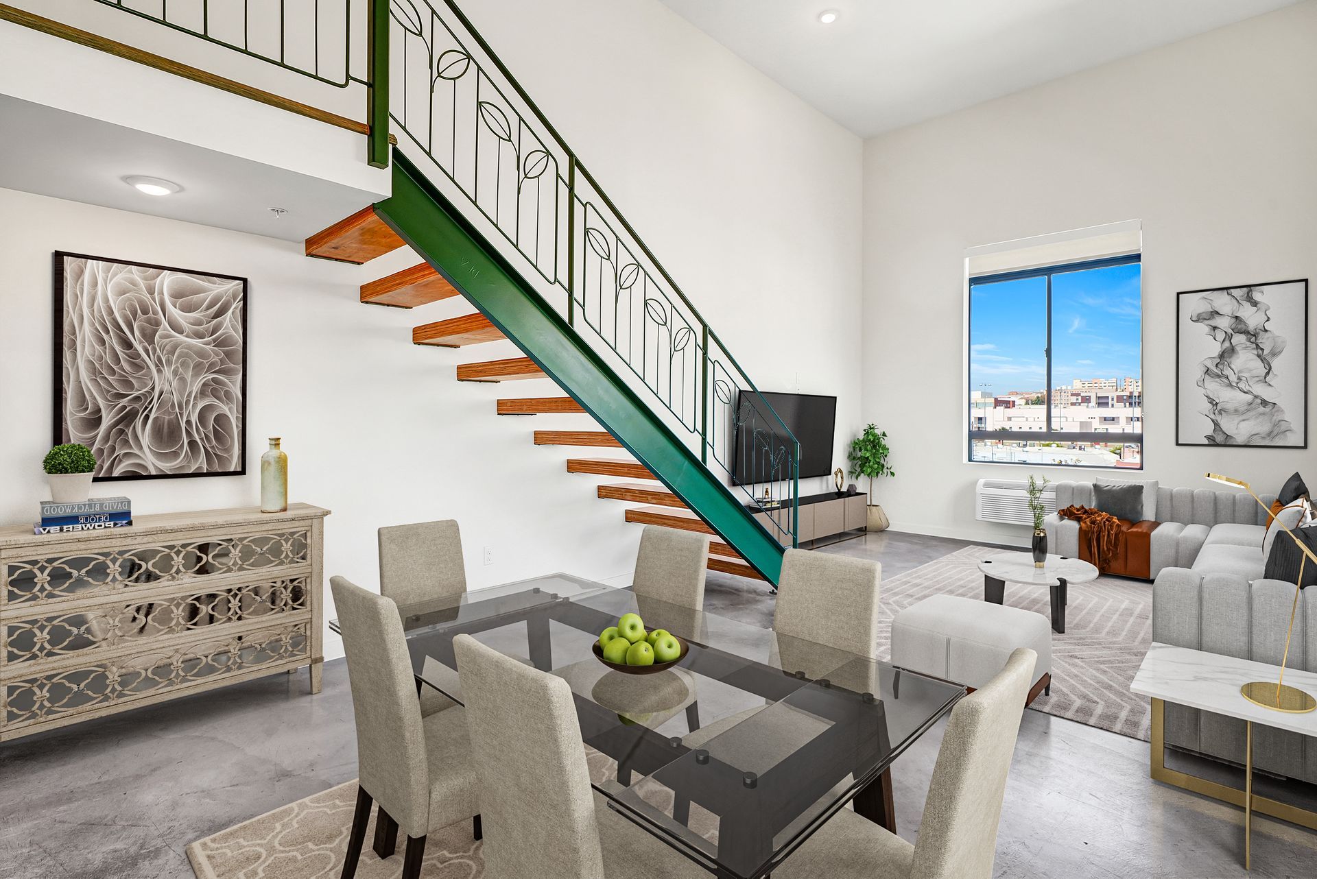 A living room with a staircase leading up to the second floor.