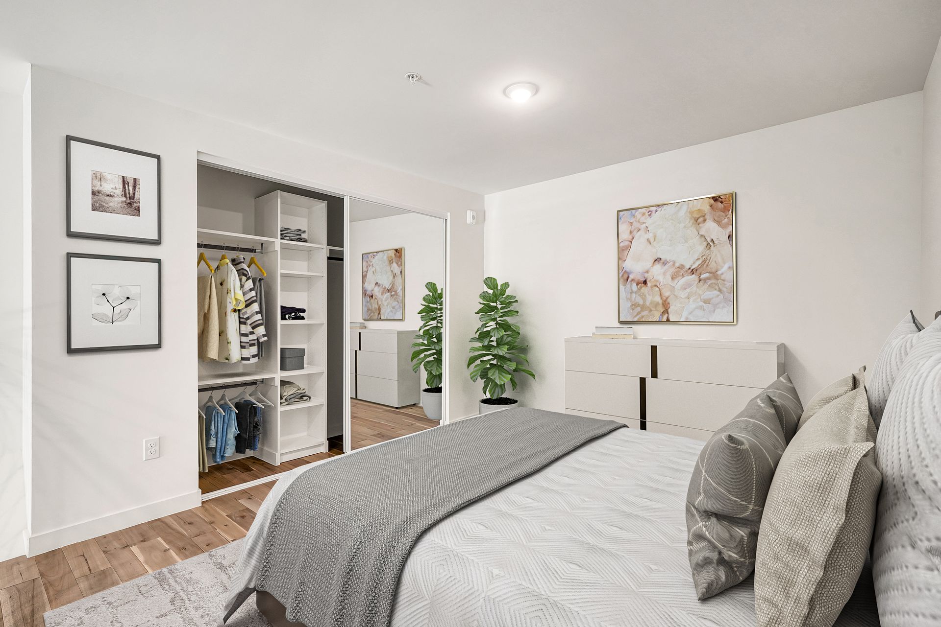 A bedroom with a large bed and a walk in closet.