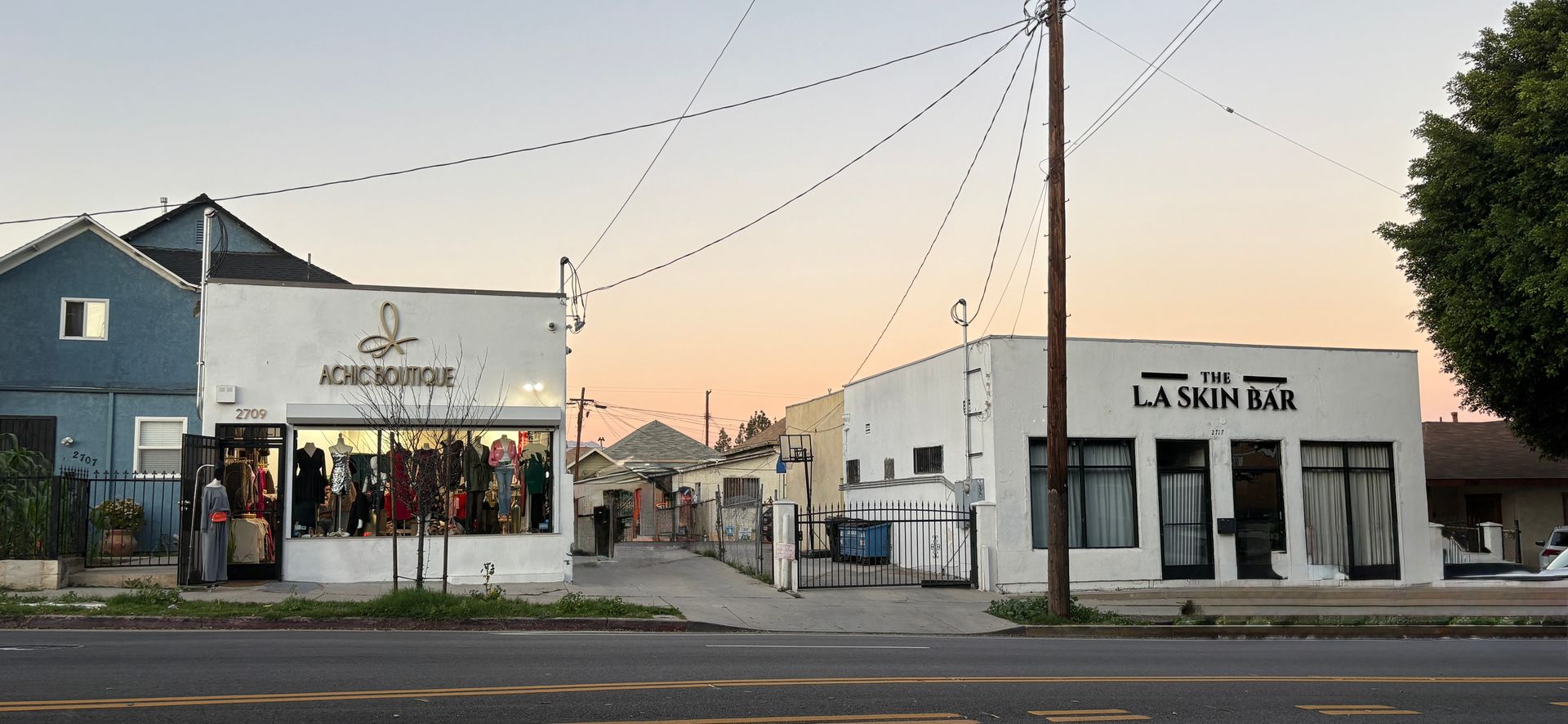 Buildings on a street at dusk: one with 