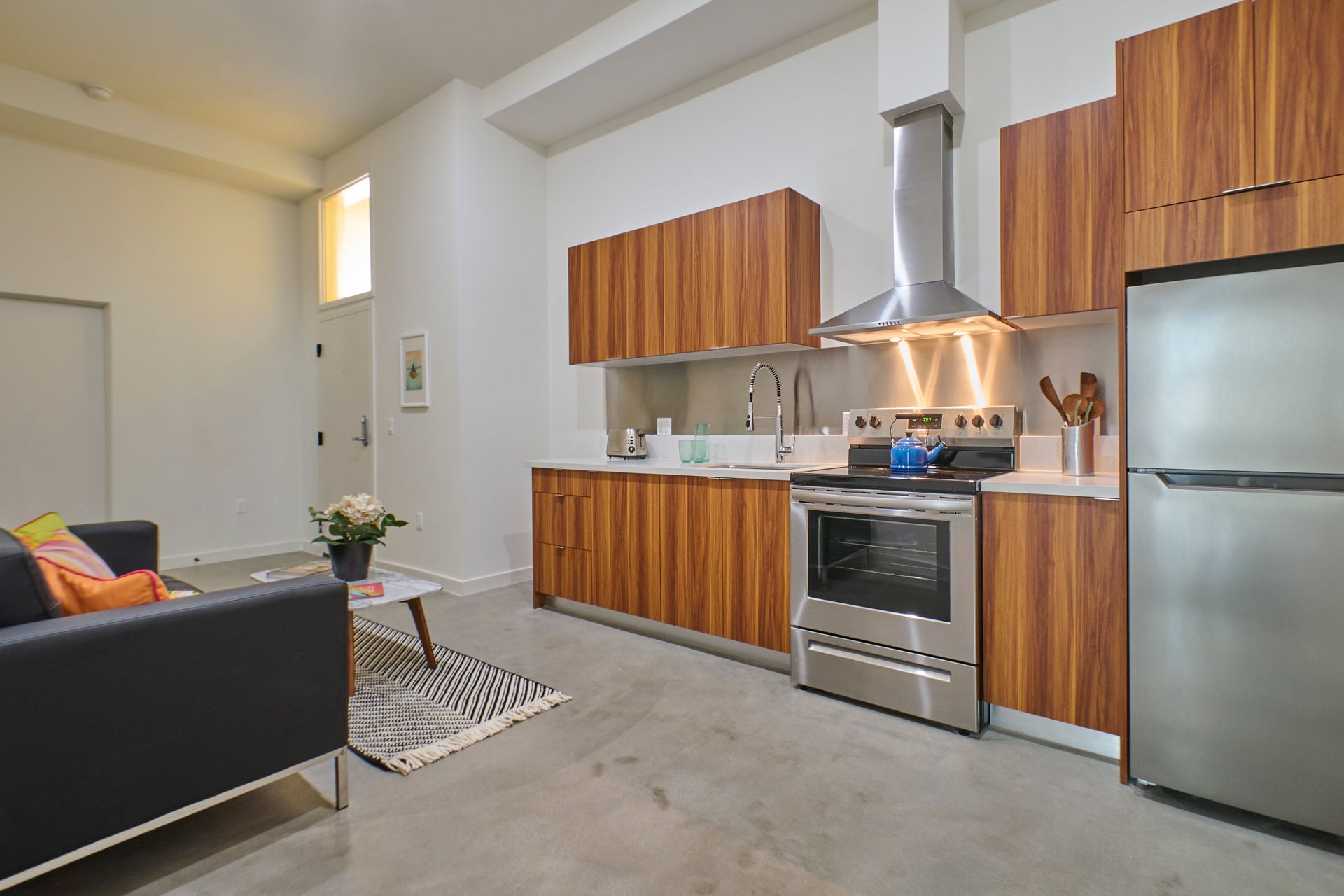 A kitchen with stainless steel appliances and wooden cabinets