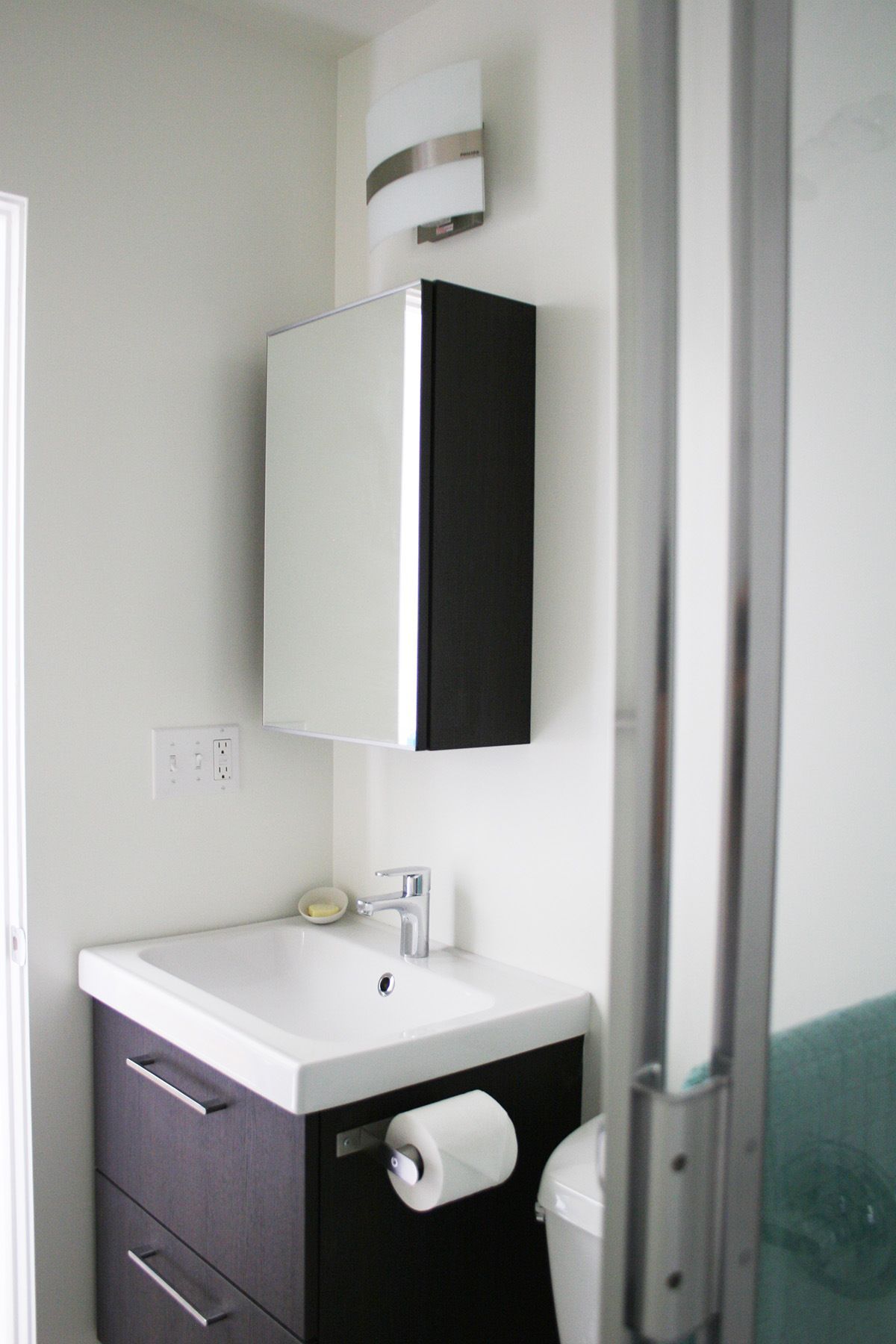 A bathroom with a sink , toilet and mirror