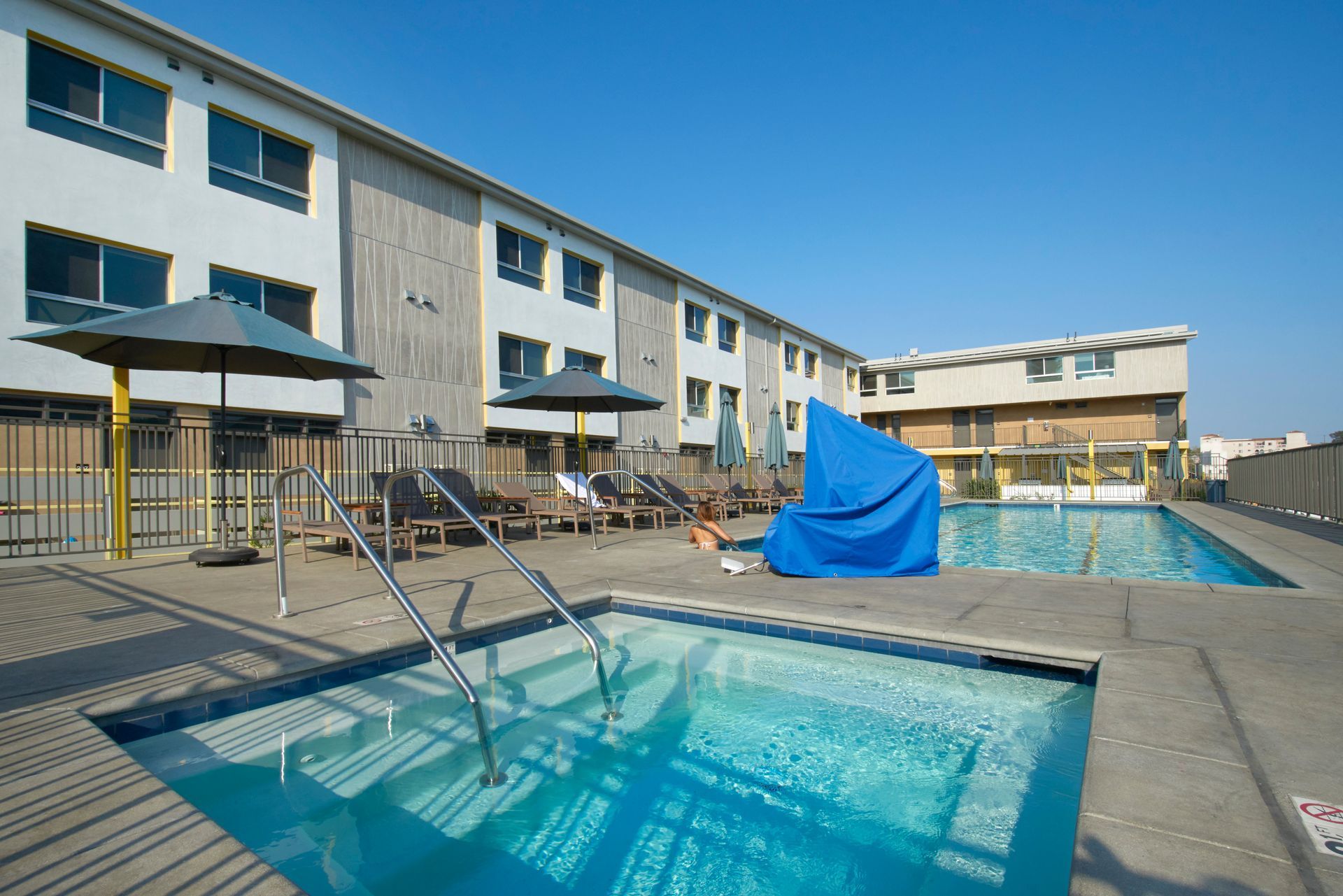 A large building with a swimming pool in front of it