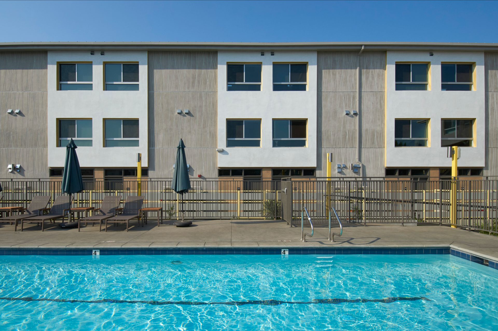 A large building with a swimming pool in front of it