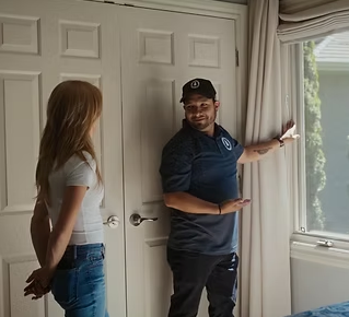 White van drives down a road, the side displays 