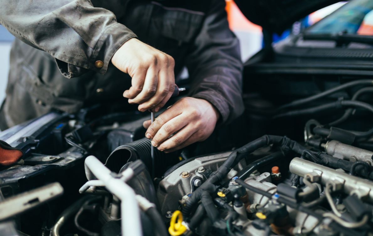 A Man is Working on the Engine of a Car — NT Auto Repairs in Winnellie, NT