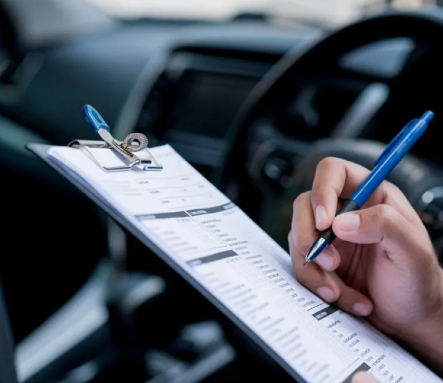 A Man is filling in a car registration form — NT Auto Repairs in Winnellie, NT