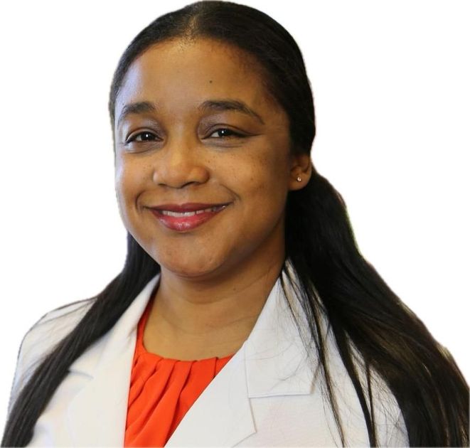 Smiling professional in a white coat and orange top against a white background