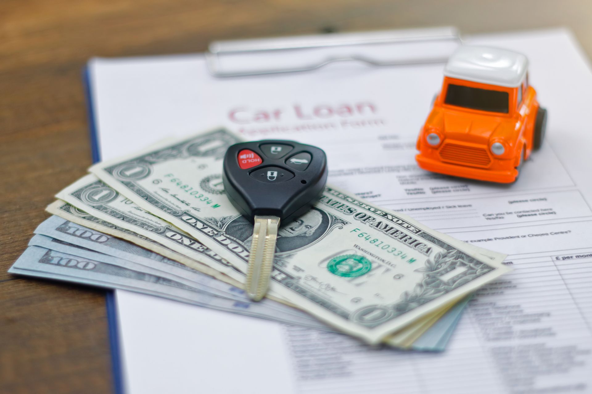 Car loan application with car keys and model car.