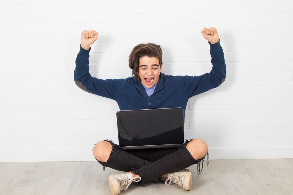 Teenager cheering after acing a test after a test anxiety hypnotherapy session