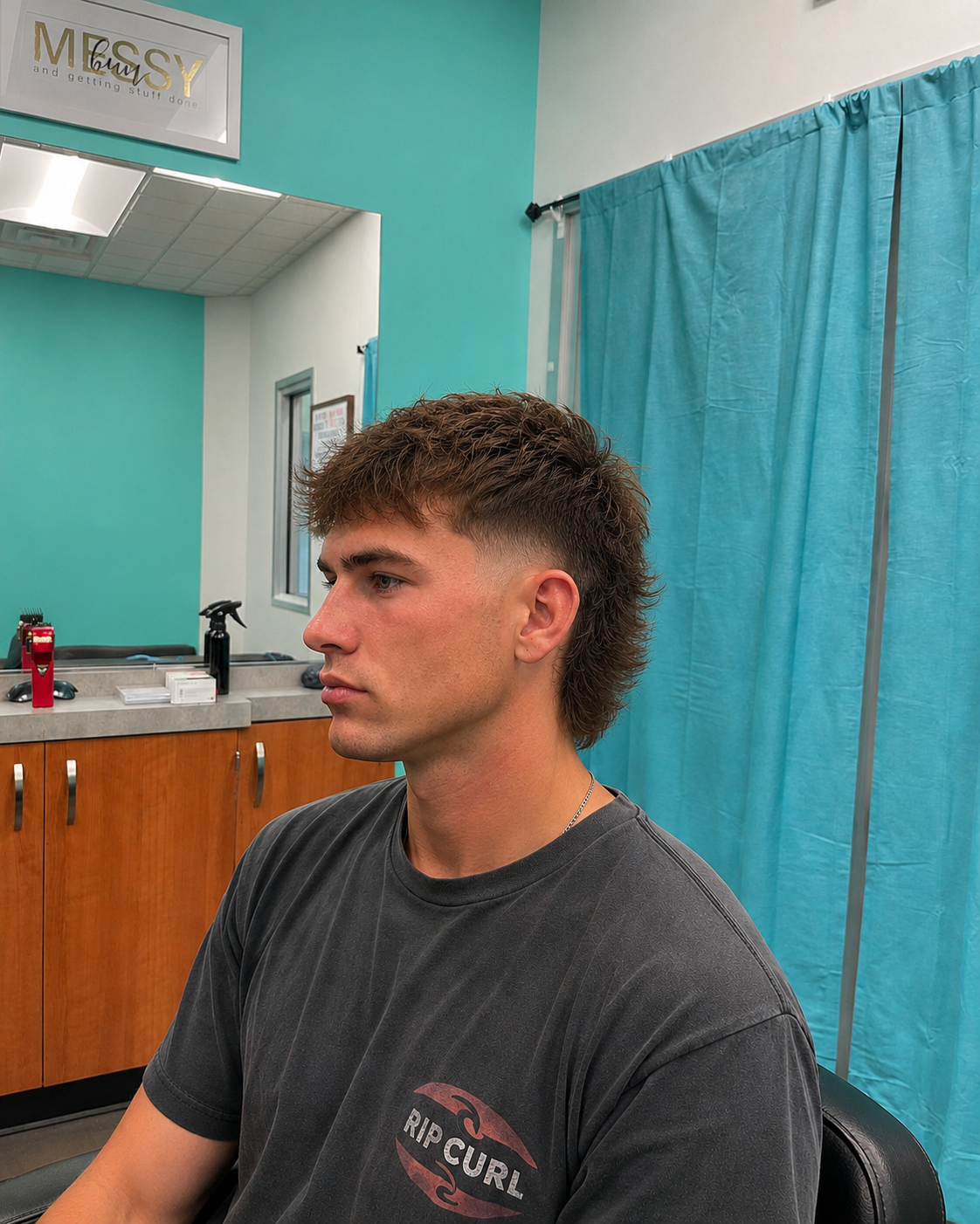 Modern mullet haircut with a low fade and textured layers.