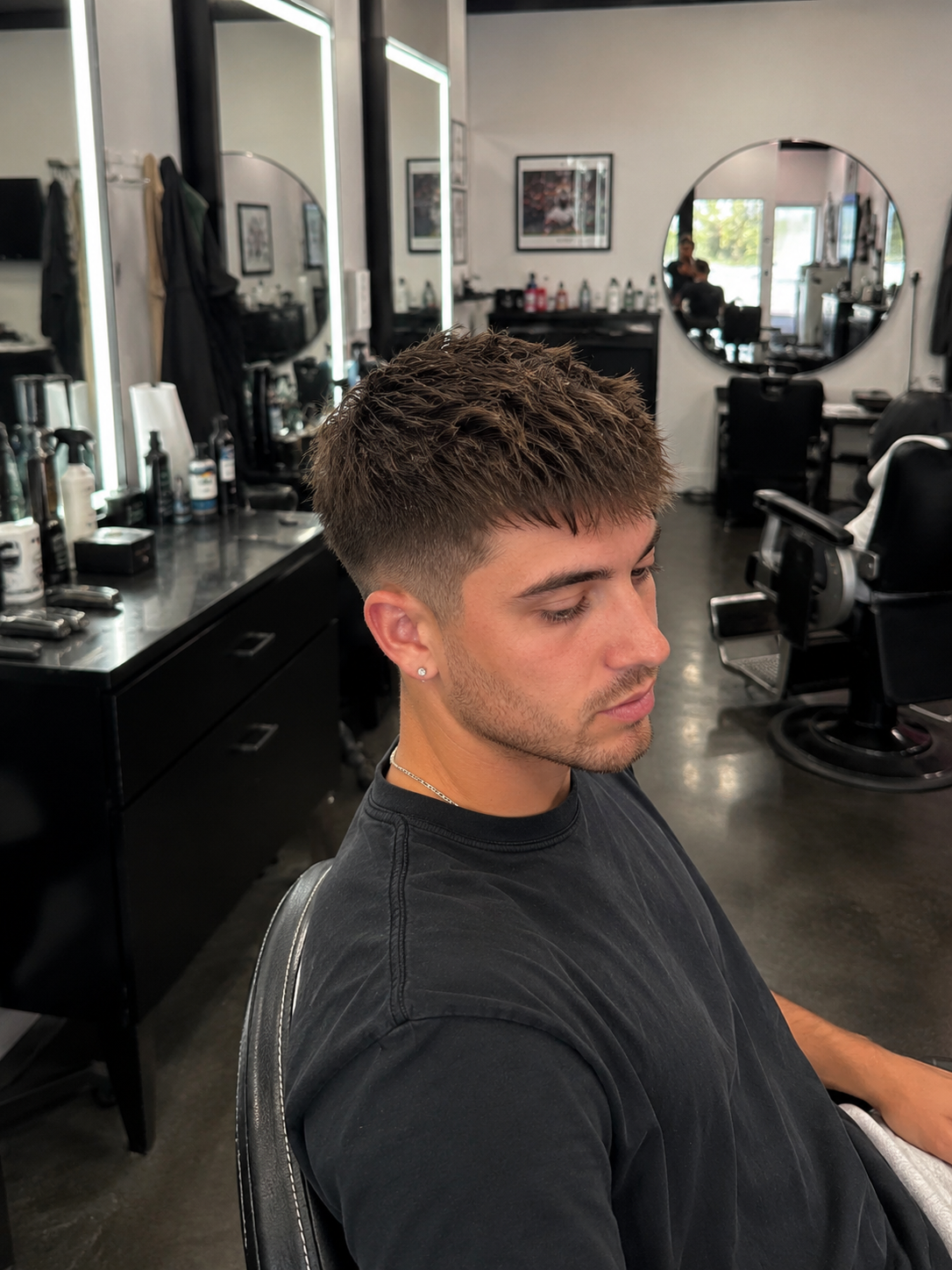 Textured crop haircut with a low fade and natural volume, showcasing modern men's barbering and clean blending.
