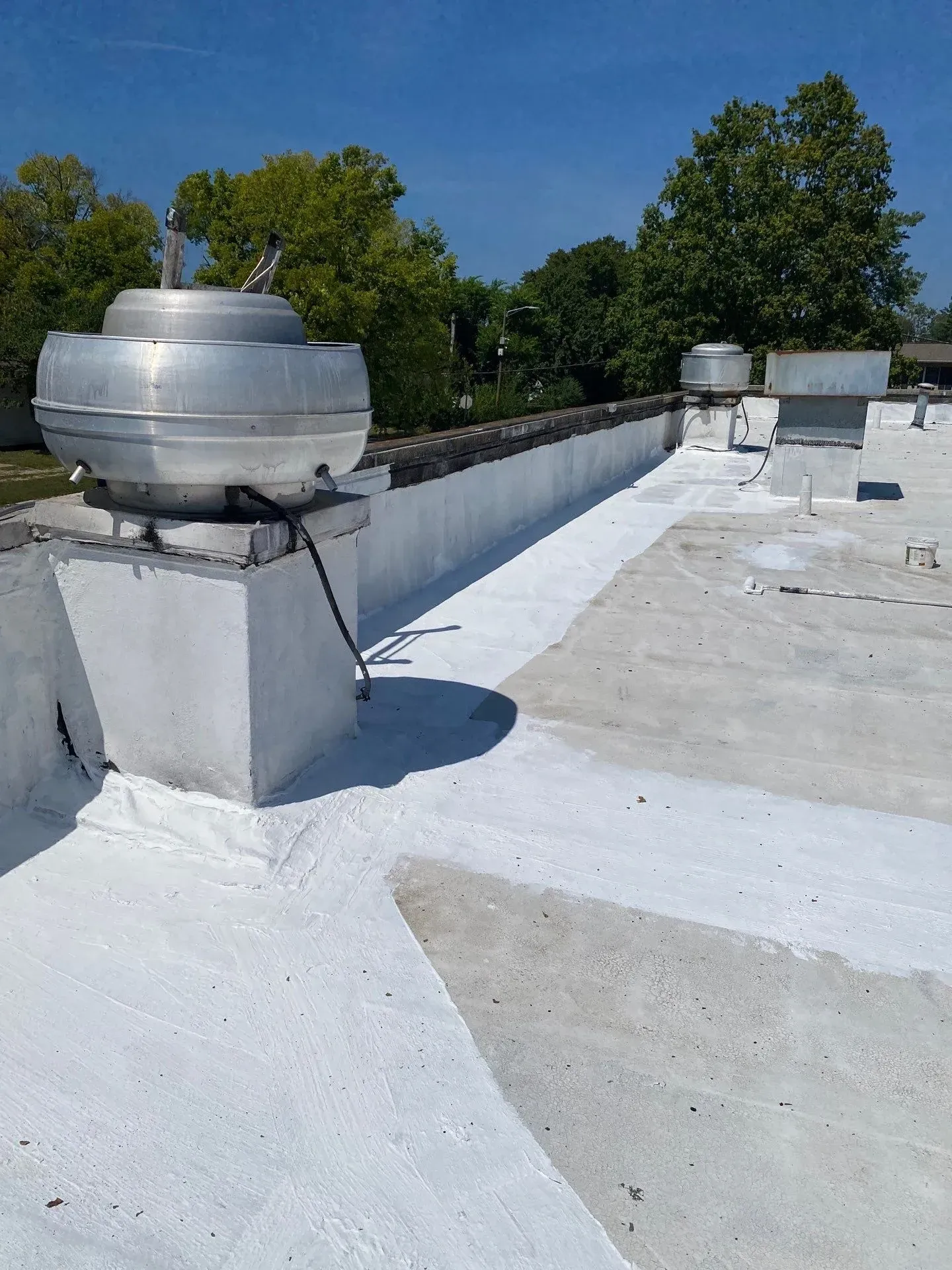 Technician applying touch-up coating during a roof maintenance visit in Bowling Green, Kentucky