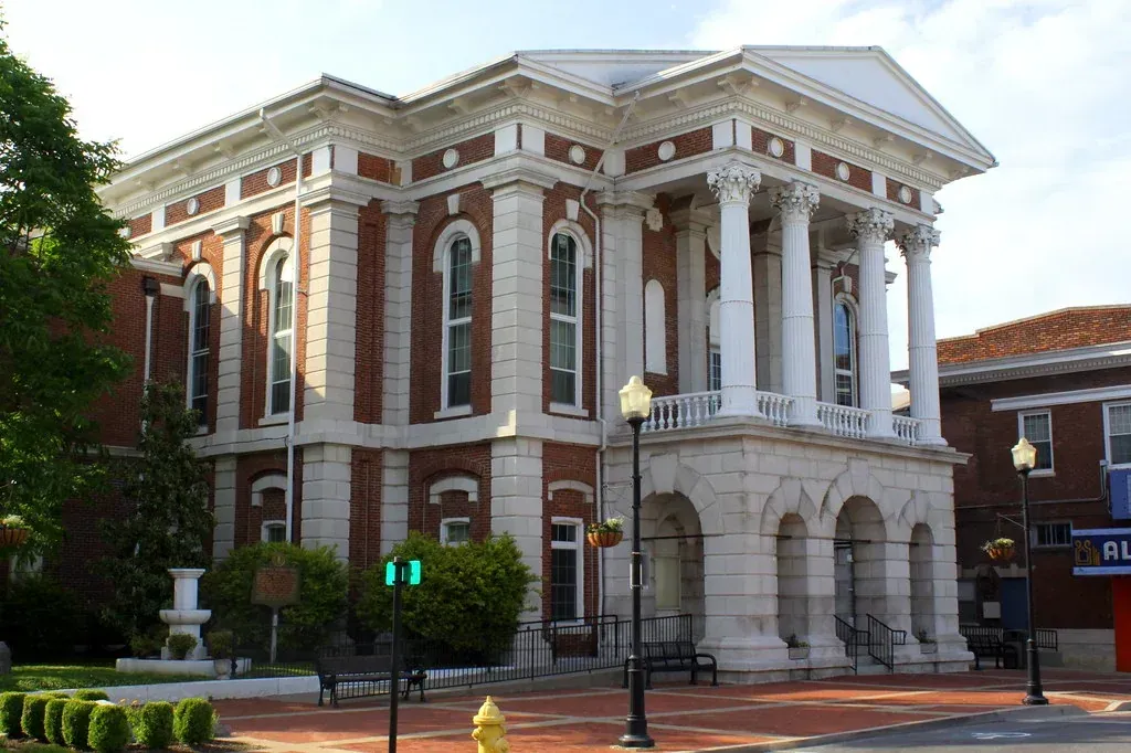 Historic Christian County Courthouse in downtown Hopkinsville, Kentucky, with red brick facade and white Corinthian column portico