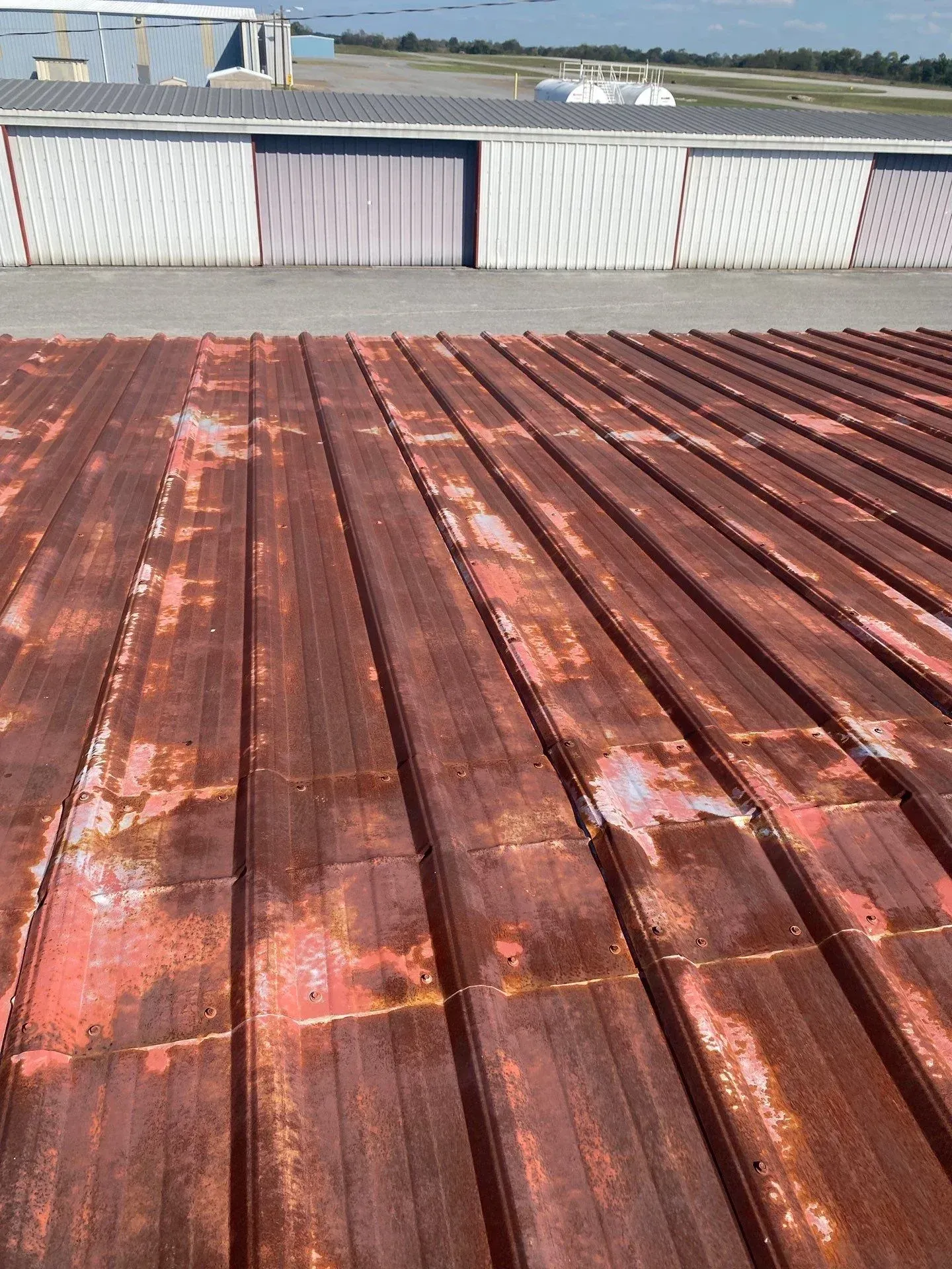 Close-up of severely rusted and corroded metal roof panels before restoration in Hopkinsville, Kentucky