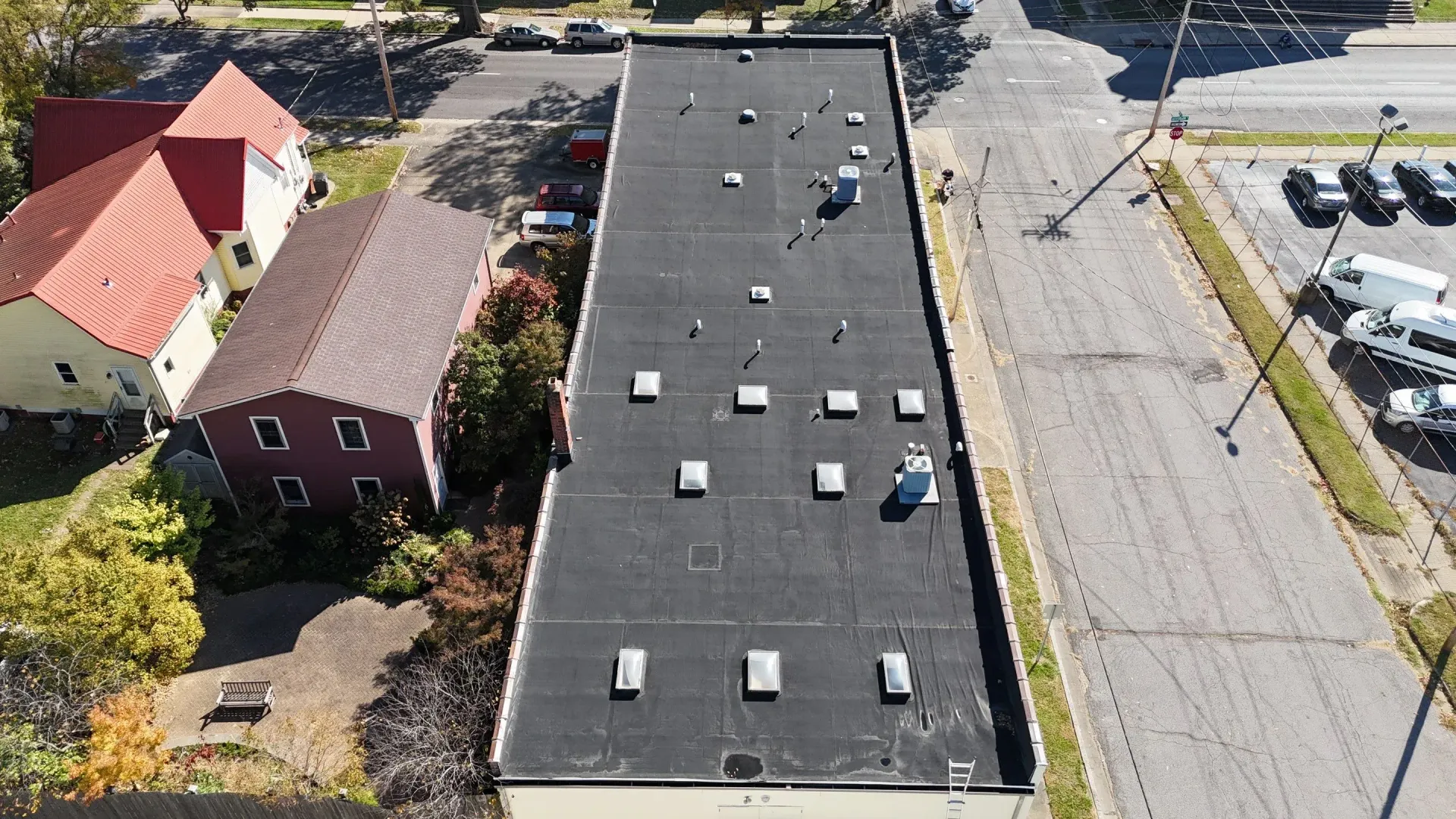 Aerial view of aging dark commercial roof membrane before restoration in Paducah, Kentucky