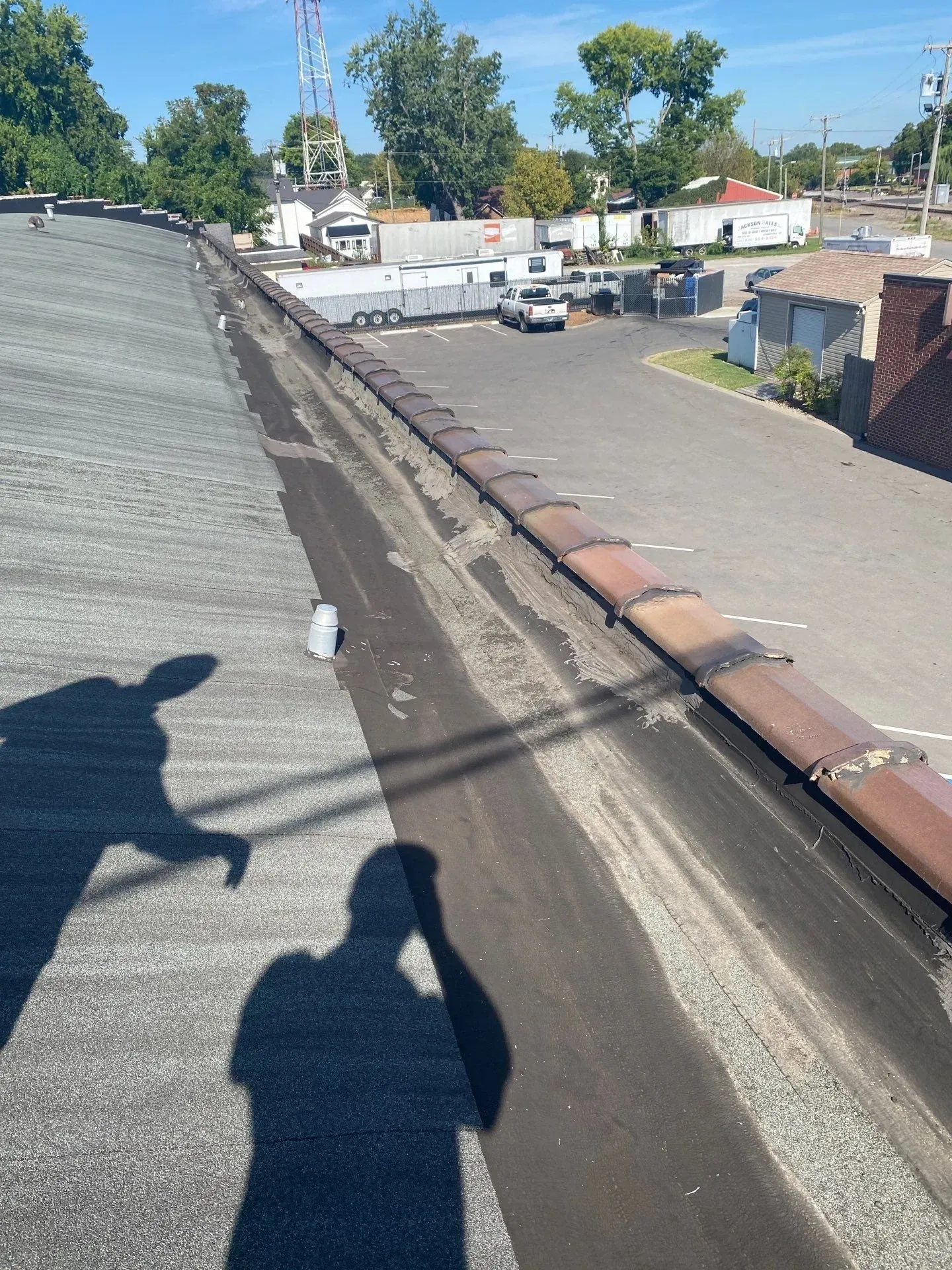 Severely rusted and deteriorated metal roof coping along a roof valley before restoration in Springfield, Tennessee