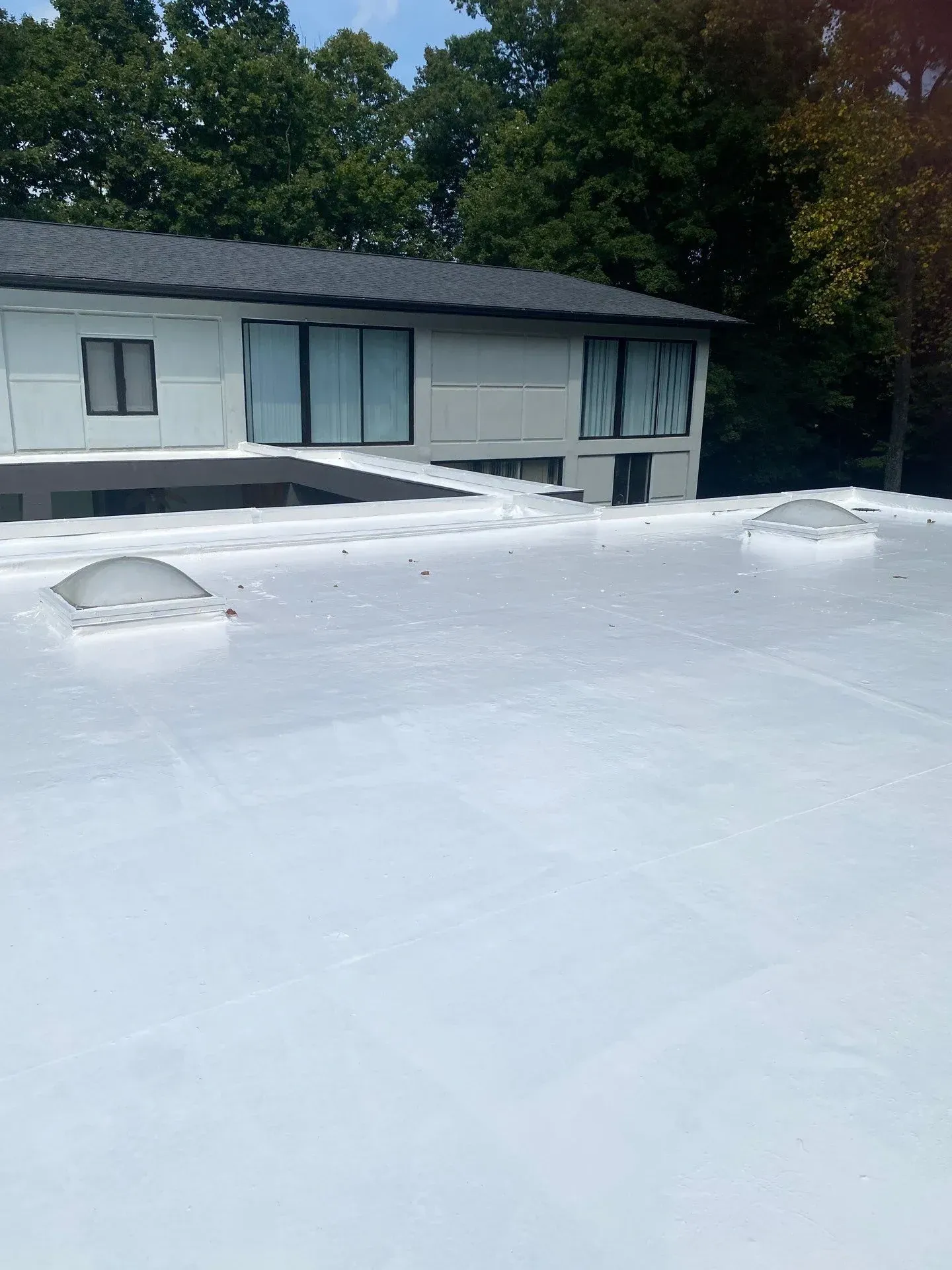 Close-up of completed white reflective coating on a residential flat roof