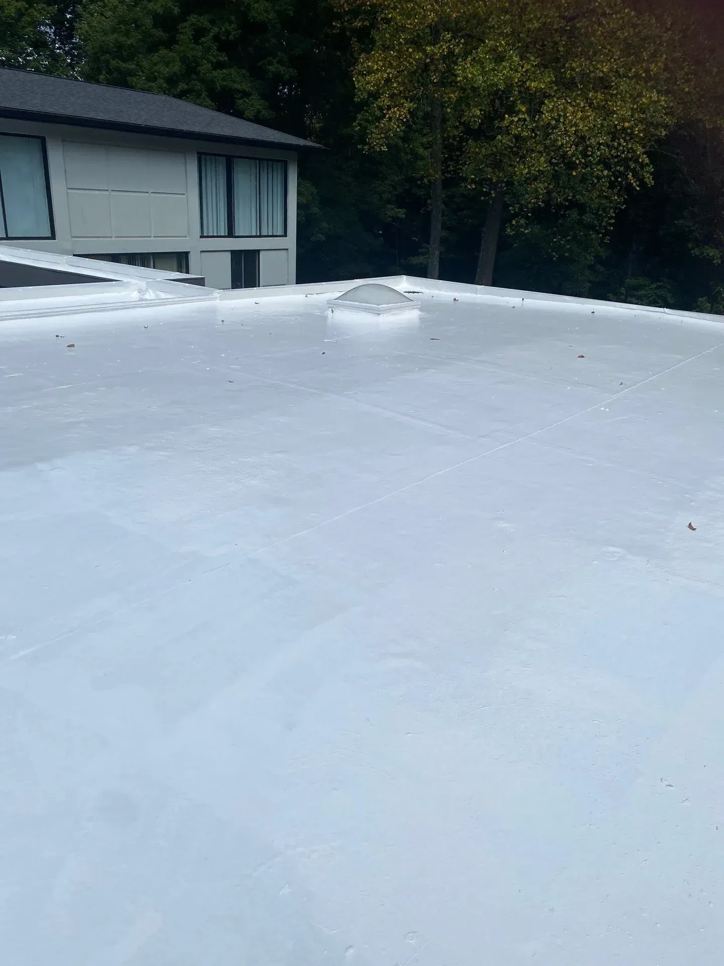 Freshly coated white flat roof on a residential property in Tell City, Indiana