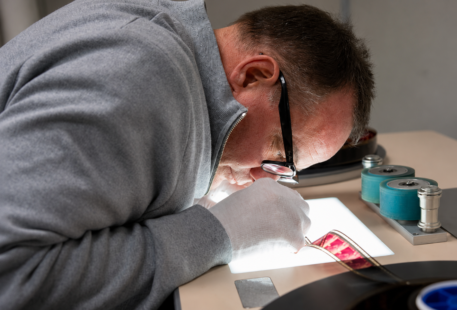 Shawn Rhodes examining archival film
