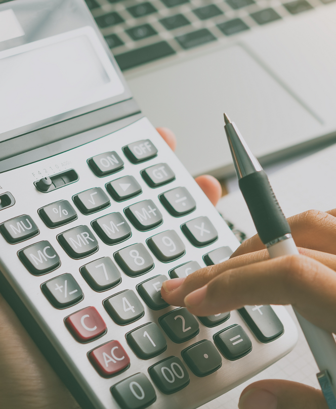 A person is typing on a calculator with a pen