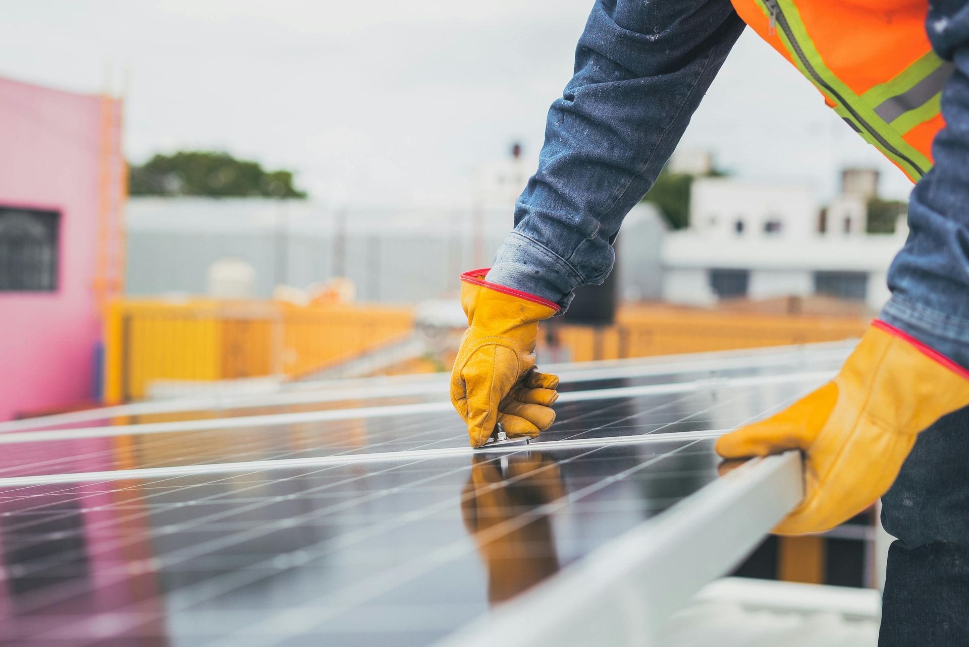 A man is working on a solar panel on a roof.