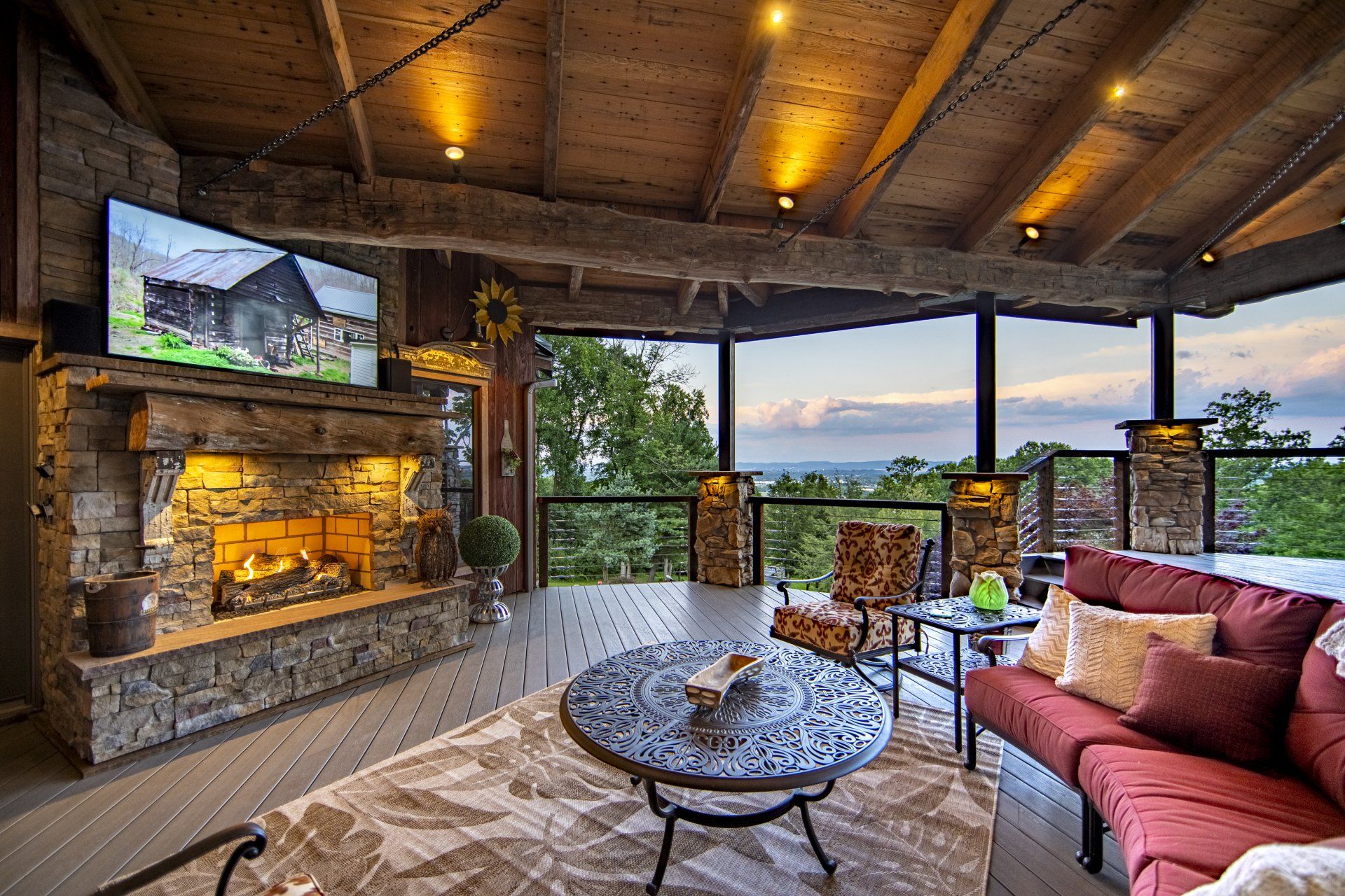 A living room with a fireplace , couch , table and television.