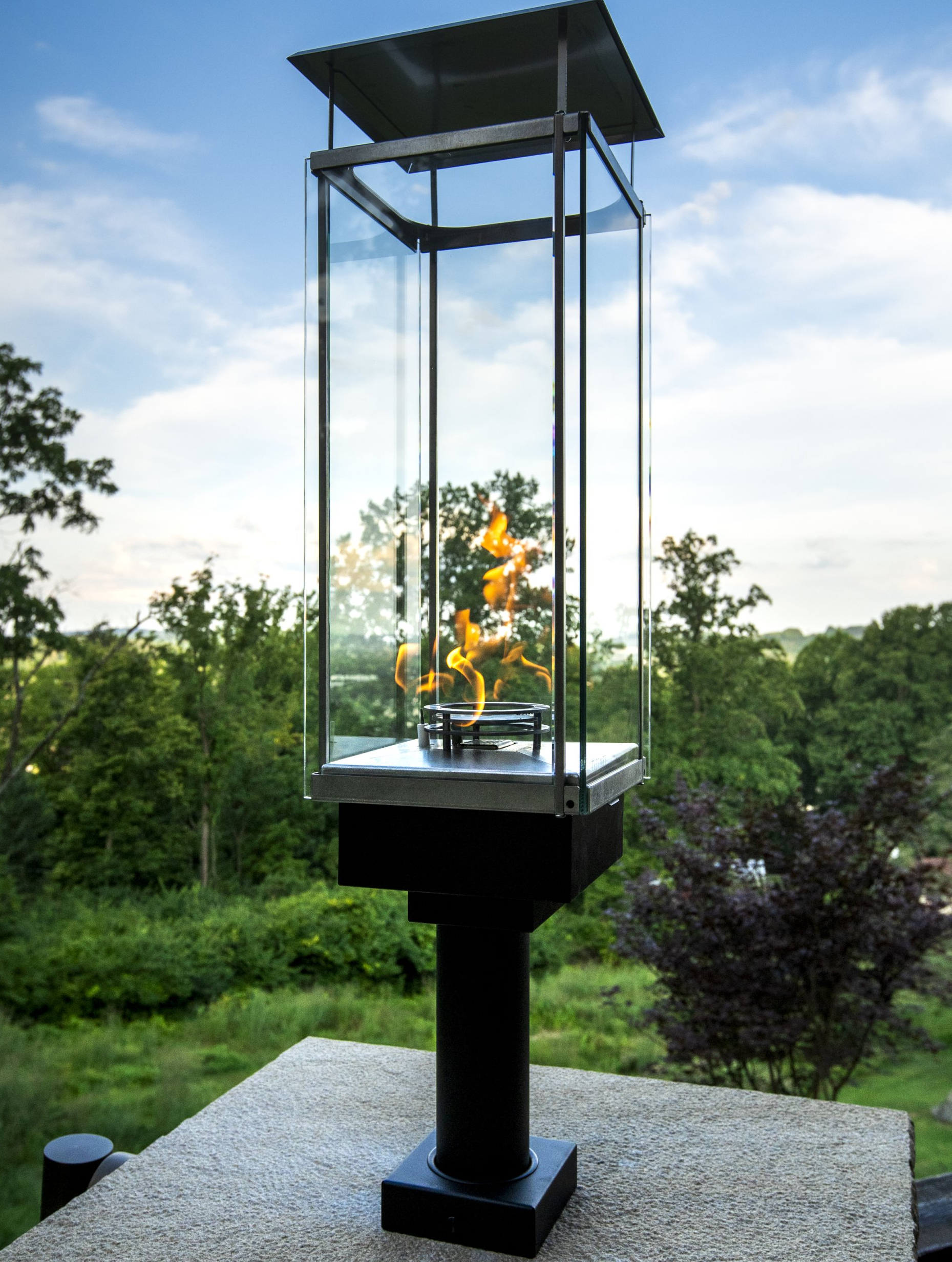 A glass lantern with a fire inside of it