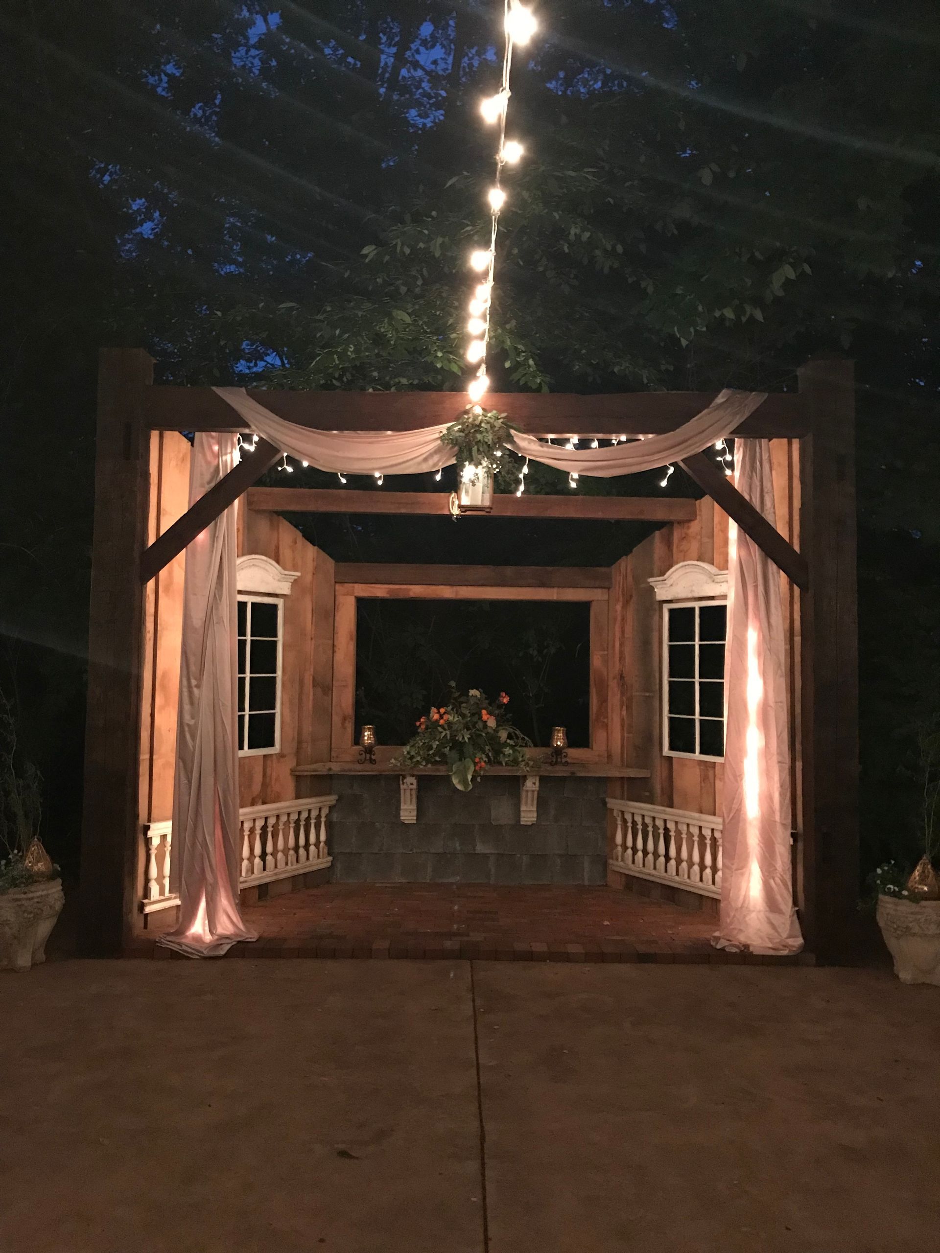 A wooden structure with lights hanging from the ceiling