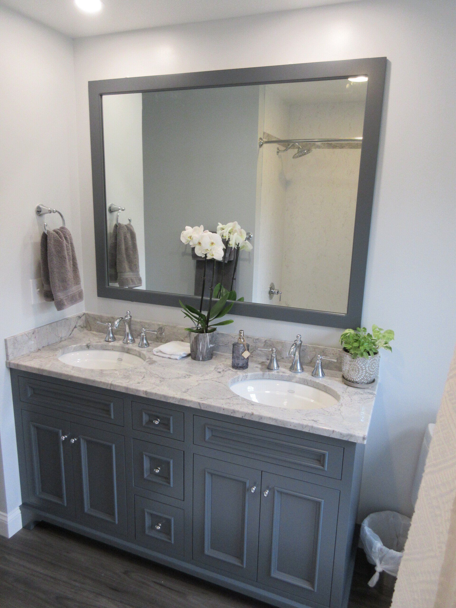 A bathroom with two sinks and a large mirror