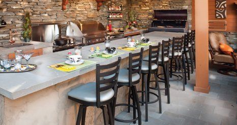 A kitchen with a long counter and stools