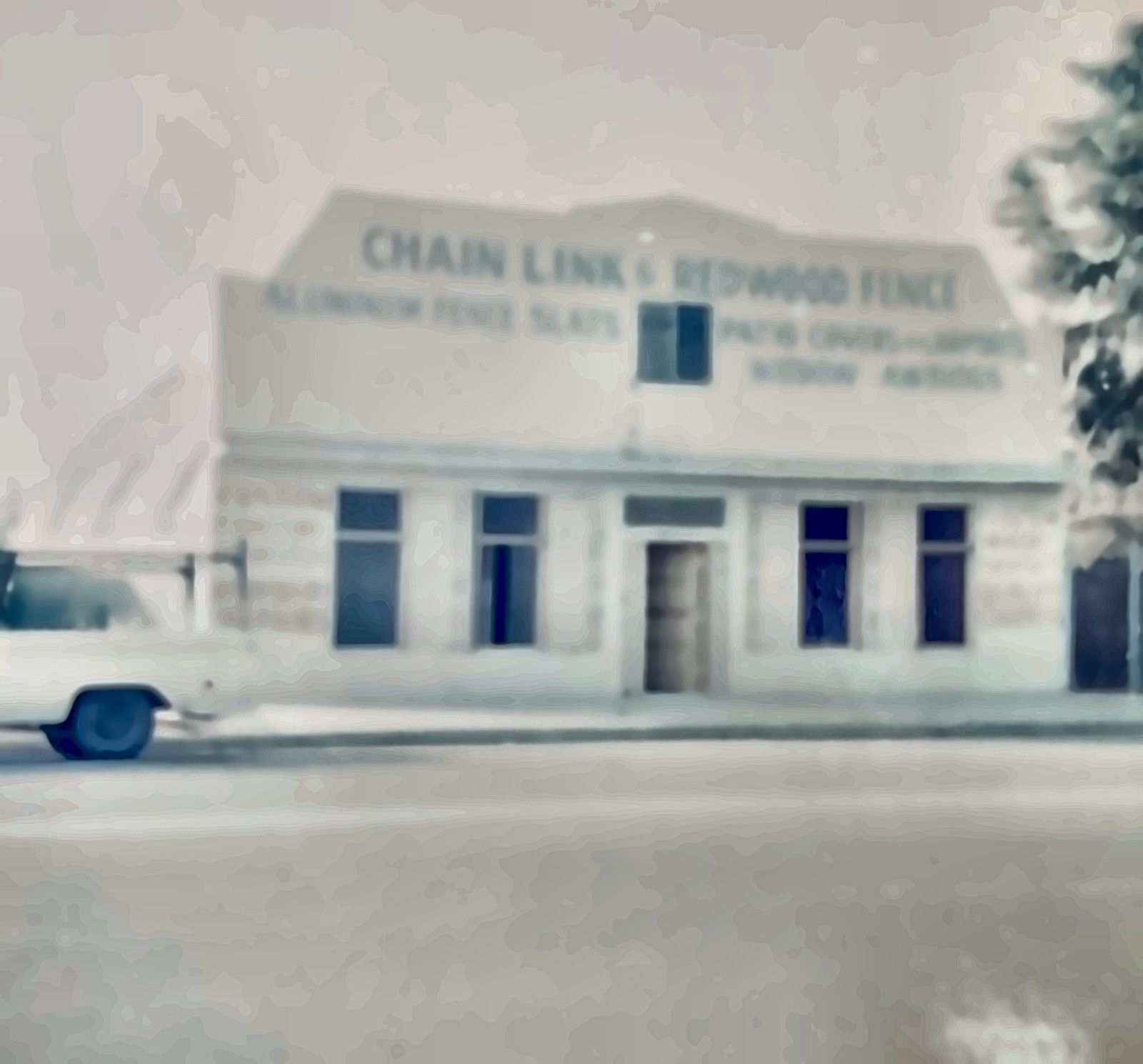 Original C&H Fence & Patio storefront with signs for chain link and redwood fence.