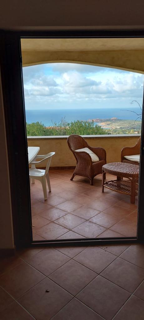 Un balcone con sedie e un tavolo con vista sull'oceano
