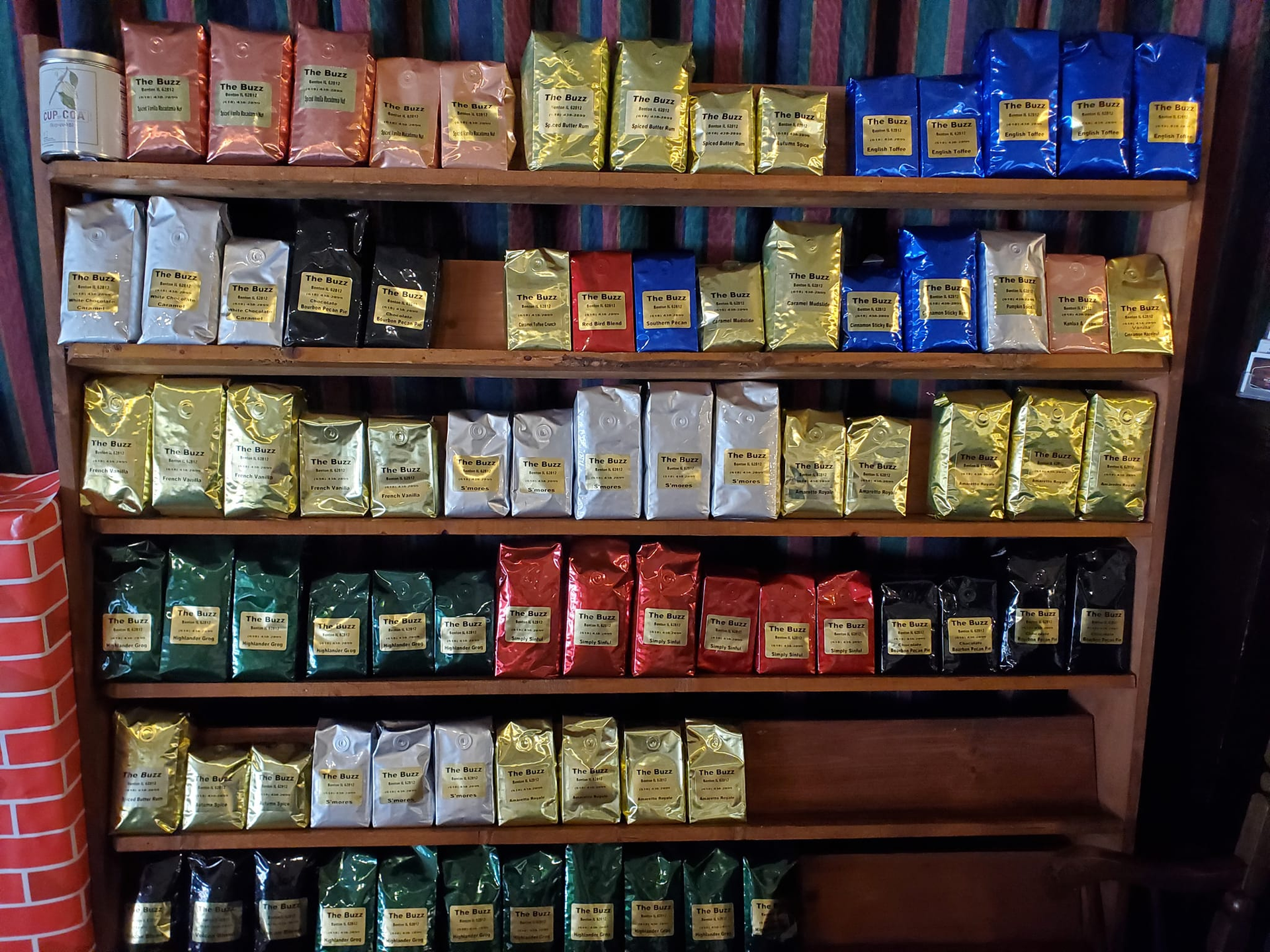 Shelves displaying various colorful bags of coffee.