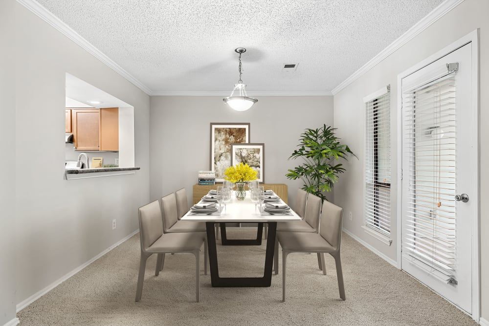Apartment dining room with a table and chairs at Marquis at Perimeter Center in Atlanta, GA.