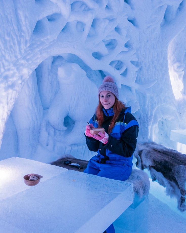 girl sitting in the ice hotel in tromso norway drinking soup