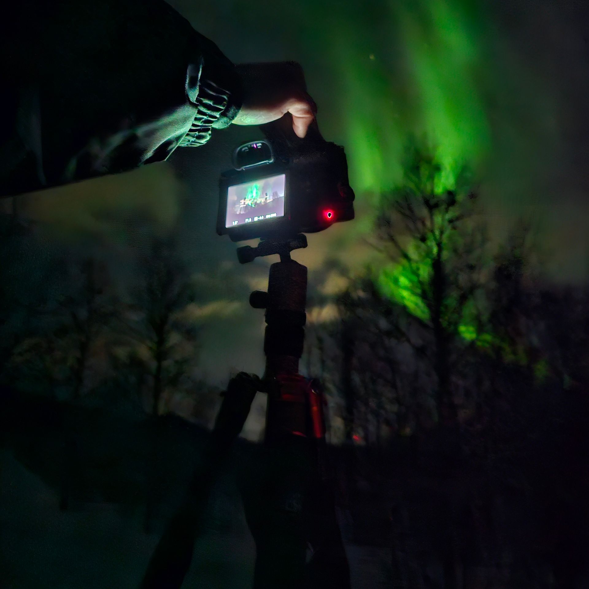 camera set on tripod capturing the northern lights