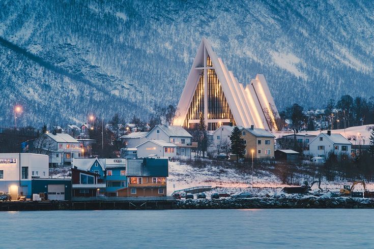 tromso cathedral and the mountain covered in snow and sea view