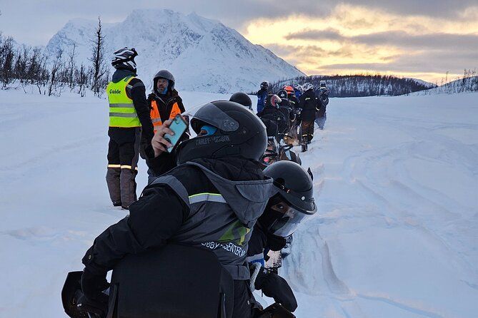 Snowmobile activity in Tromso city people dressed in winter clothing 
