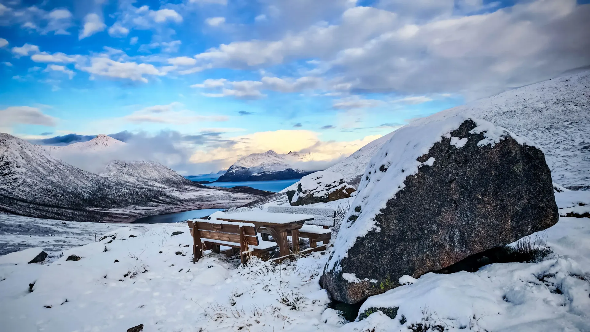 Expansive winter snow landscape and mountain fjord scenery near Tromsø in Northern Norway