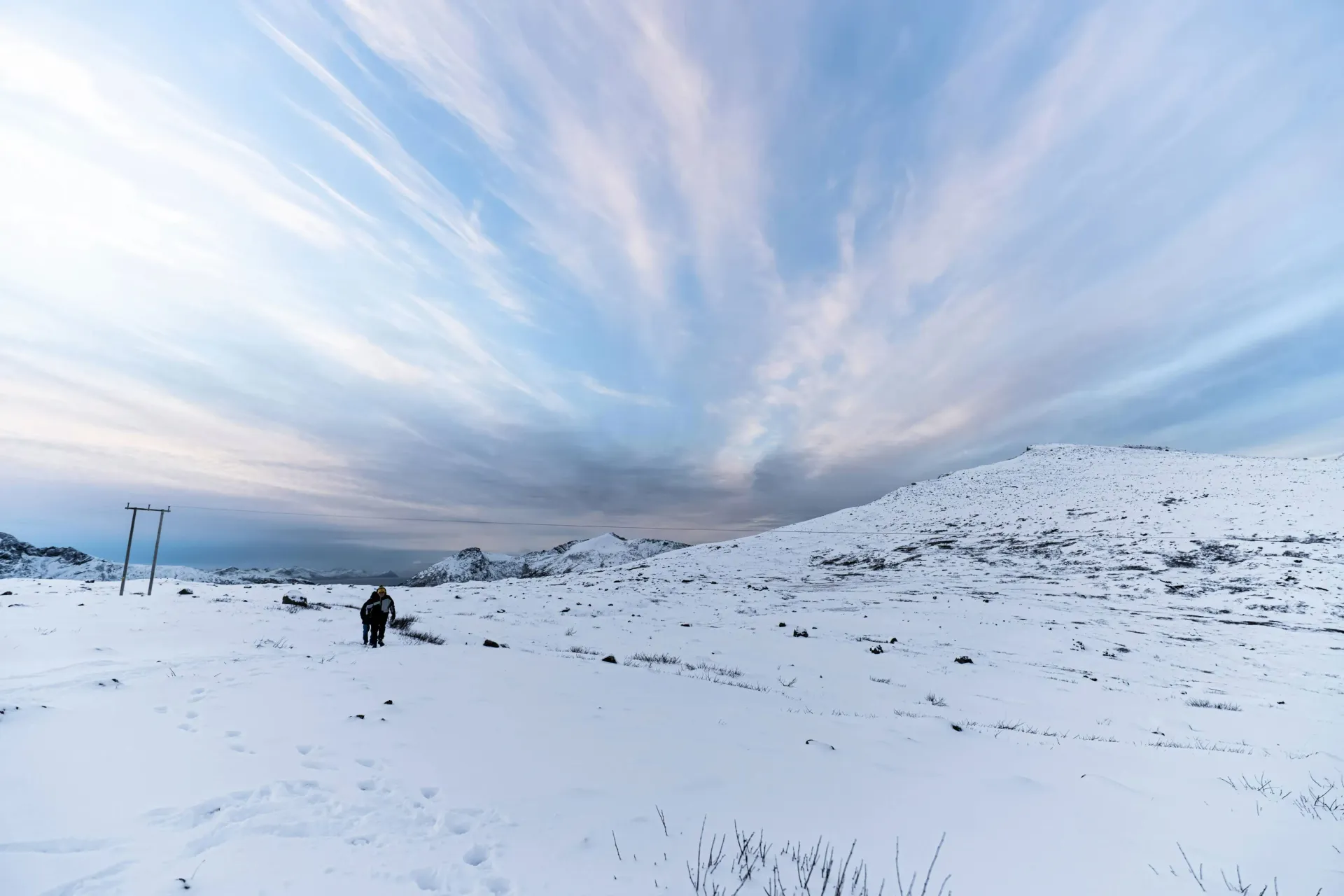 Scenic coastal Arctic fjord and snow-dusted mountains during daytime sightseeing in Northern Norway