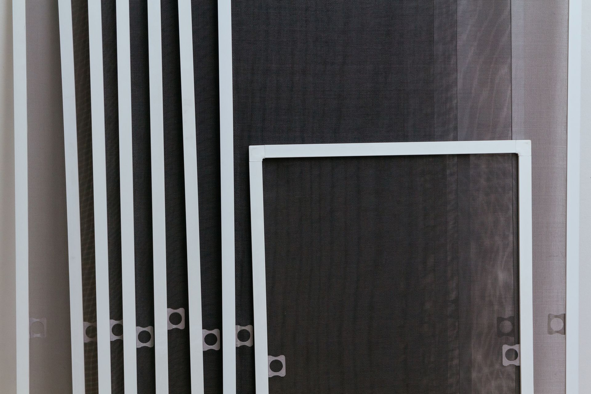Black-and-white striped wall with a small rectangular white-framed opening or door