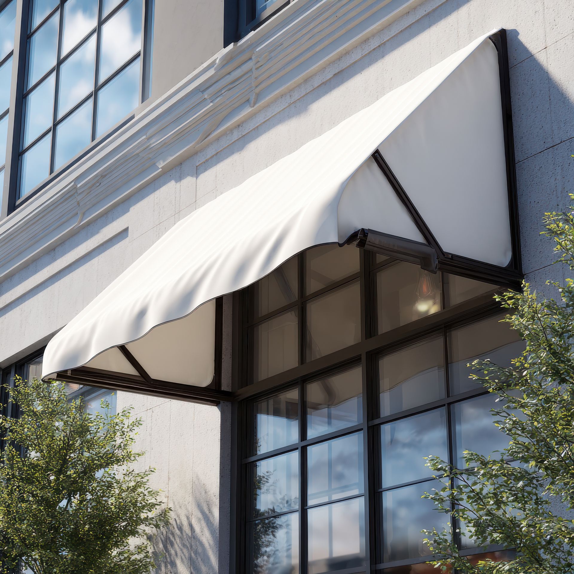 White awning over a glass entrance on a building facade with trees nearby