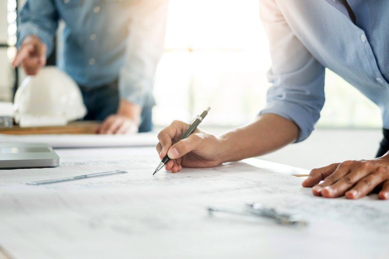 An architect working on a glass storefront drawing.