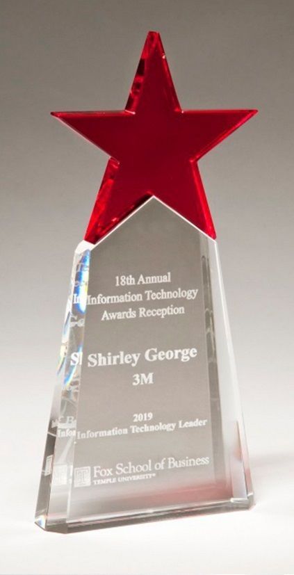 Crystal recognition award with red star.