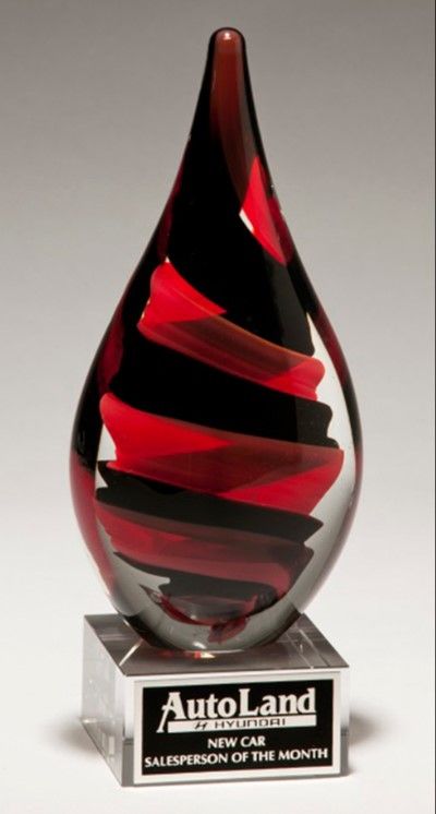 Red and black swirl teardrop glass recognition award.