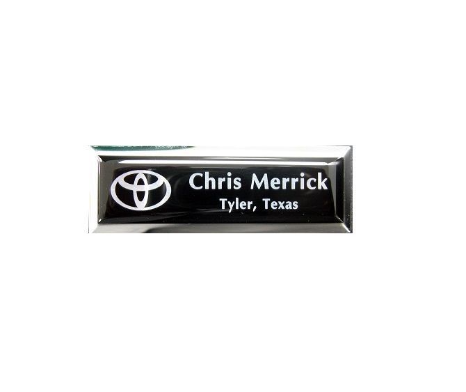 Laser engraved and protective domed black aluminum badge on small premier silver frame.