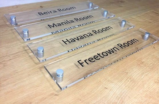 Vinyl lettering on acrylic corporate office signs.
