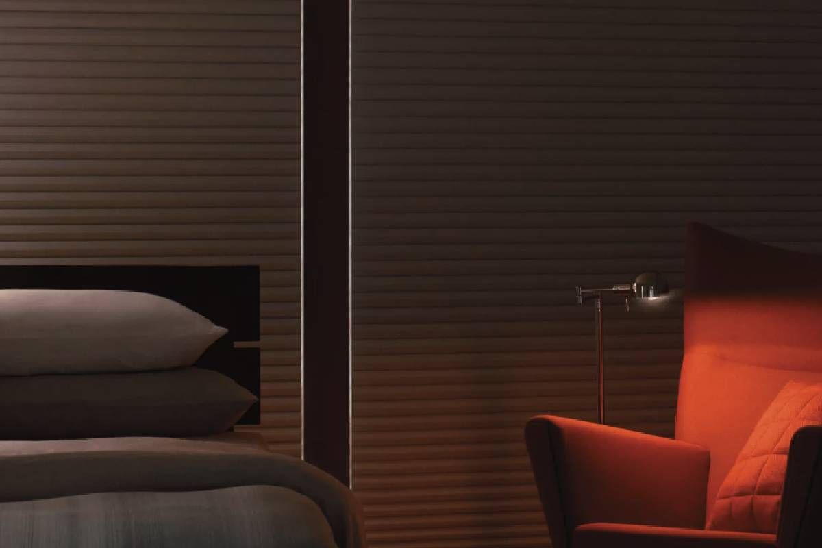 Hunter Douglas Duette® Architella® Room Darkening Shades Next to a Bed and Chair near Elkhorn, Nebraska (NE)